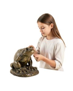 Girl Looking At A Frog Statue